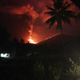 Mount Soputan is illuminated by a nighttime eruption.
